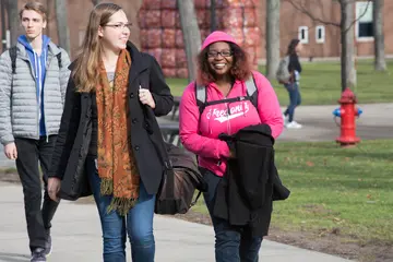 Fredonia students, like these two walking across campus, enjoy significant aid throughout their four years.