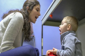 a student works with a young client on speech exercises
