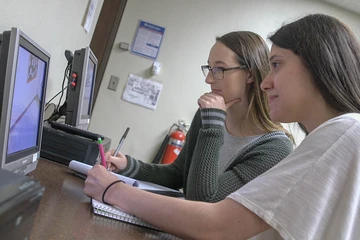 Fredonia students watch a monitor in a the Youngerman Clinic observation room