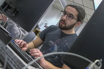 a student looks at a screen during a computer science competition