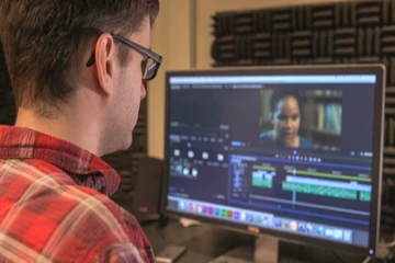a student edits a video production piece in Adobe Premiere Pro software