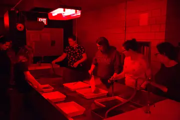 students in darkroom processing photos