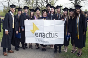 The enactus club poses for a group photo at commencement
