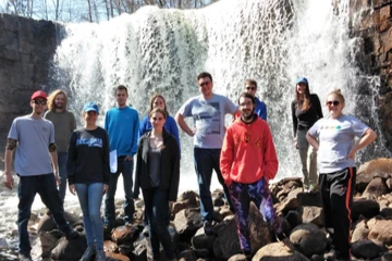 fredonia geology students pose in front of a waterfall