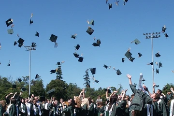 hats tossed into the air at commencement ceremony