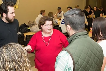 a professor engages with students in a classroom