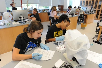 medical tech students work in a lab