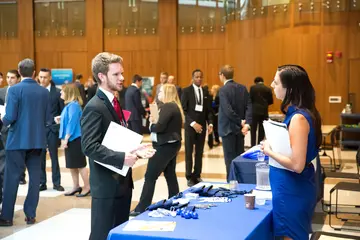 accountants chat during financial event in Williams Center