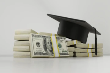 a picture of money and a graduation cap