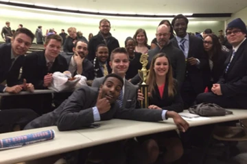 the mock trial team poses with a trophy after winning a competition