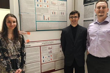 psychology students conducting undergraduate research pose in front of their research presentation posters. 