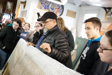 Fredonia students examine artwork in a studio, New Media degree