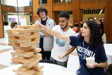 Fredonia students join in the fun playing Jenga at the campus block party