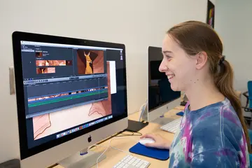 A student prepares an animation short on a computer. Graphic design degree, degree in graphic design, major in graphic design.  graphic design program, graphics design schools 
