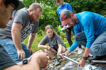 Fredonia students in Geology and Environmental Sciences like these doing research in a creek can earn a minor in environmental studies