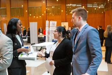 Fredonia Business students at an event meeting business professionals.  Students at Fredonia can study accounting, get an economics degree, business management, and finance degrees to prepare for a career as an entrepreneur