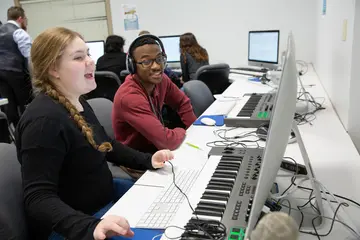 School of Music students work on a computer in a music composition course music composition program, musicology