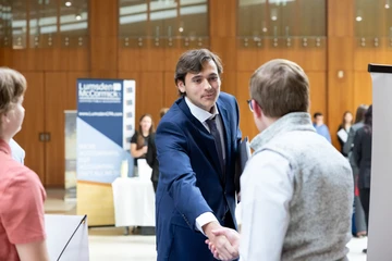 student shaking hands at meet the accountant event