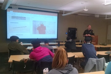 Correctional Officer Thomas Gilmore giving a talk to club members. Officer Gilmore is the Gang Intelligence Officer for the Chautauqua County Sheriff's Office