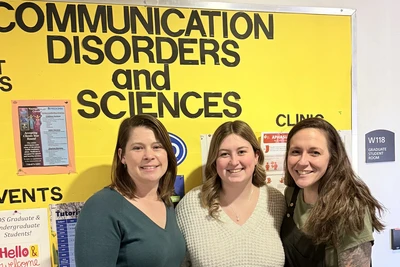 Digital photo of Honors student chosen (middle) posing with two nominators
