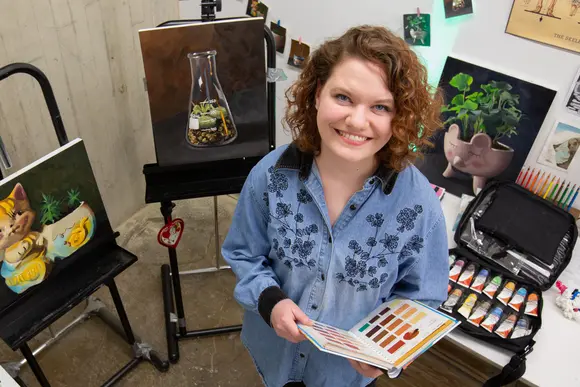Fredonia student in a painting and drawing space. Fredonia's arts programs are among the most popular majors.  