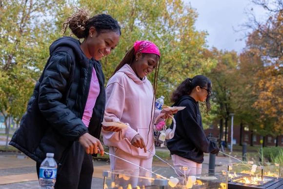students roasting marshmallows