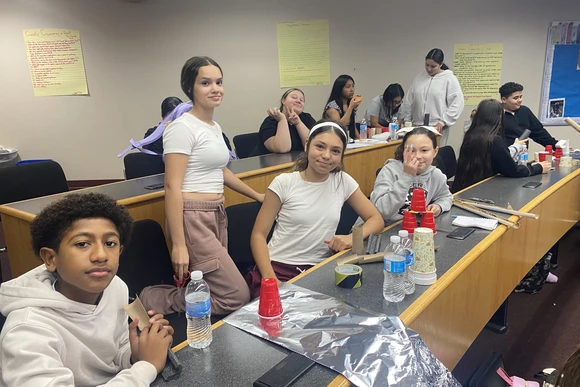 Students at Dunkirk CSD work on science projects involving plastic cups and tin foil
