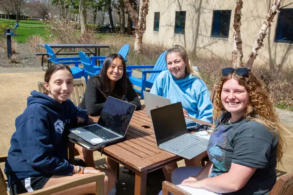 Fredonia students enjoying a beautiful spring afternoon at picnic table 