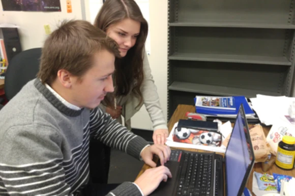Two students working on a computer