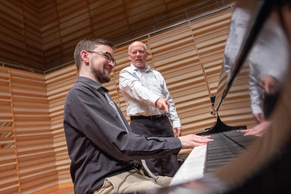 Music student works with a teacher.