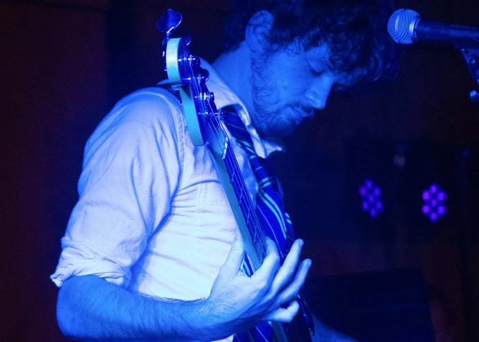 Fredonia student playing guitar at battle of the bands