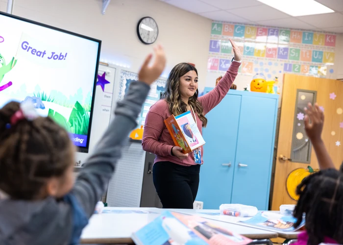 Fredonia teaching student in field experience in front of a class. 