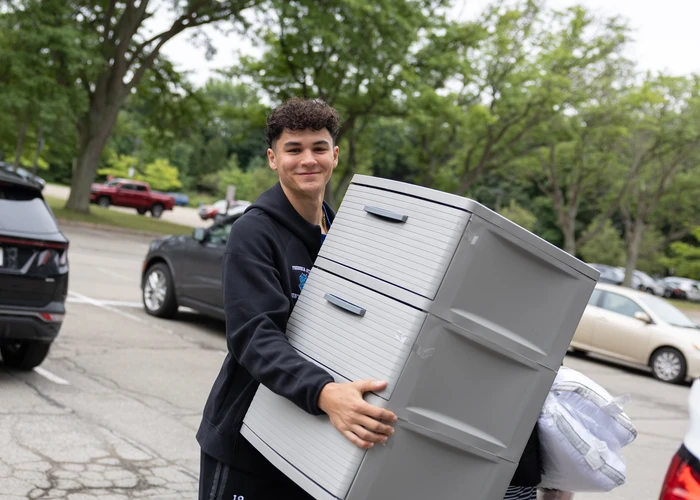 Student moving into their dorm room at the start of a new year