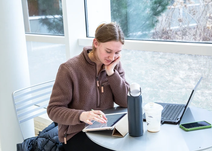 Student studying on campus in a quiet spot along