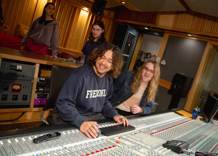 Fredonia students working in a sound recoring studio on campus 