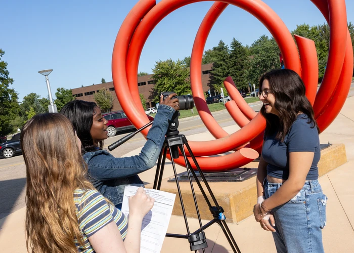 Student filmmakers making art on campus