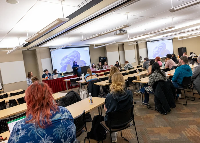 Students in EGS attend a presentation on campus