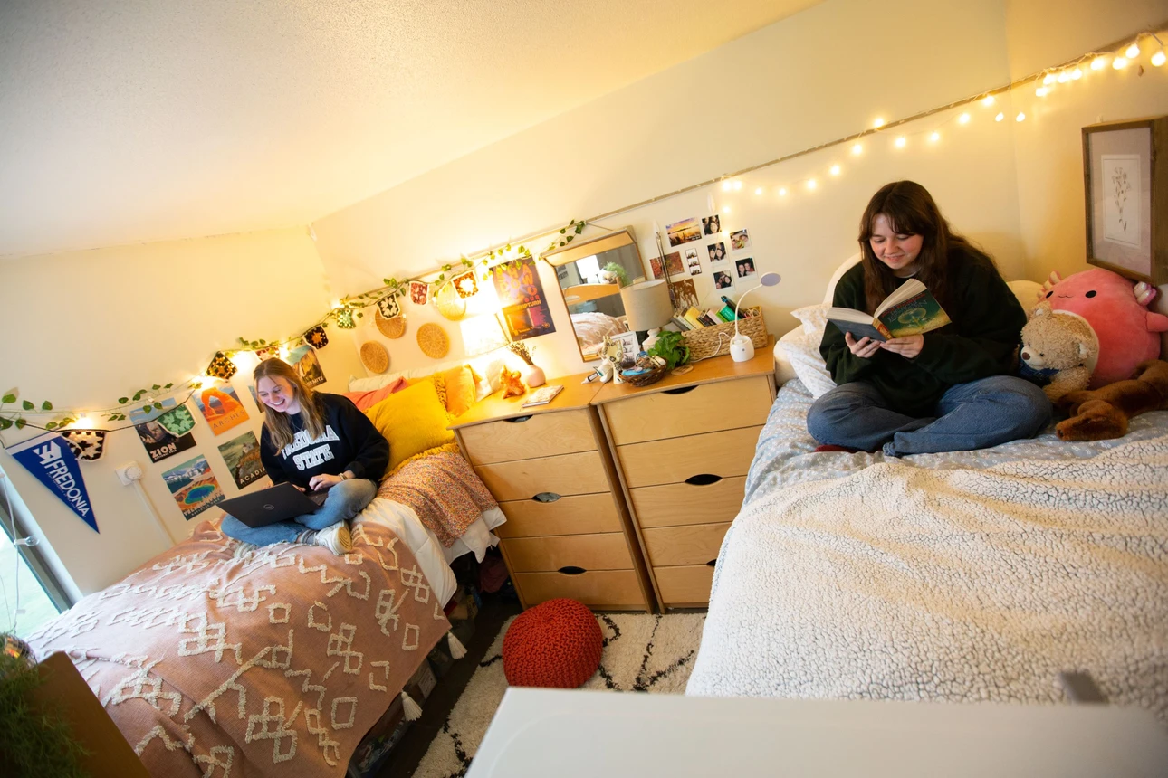 Grissom Hall bedroom featuring 2 students reading.