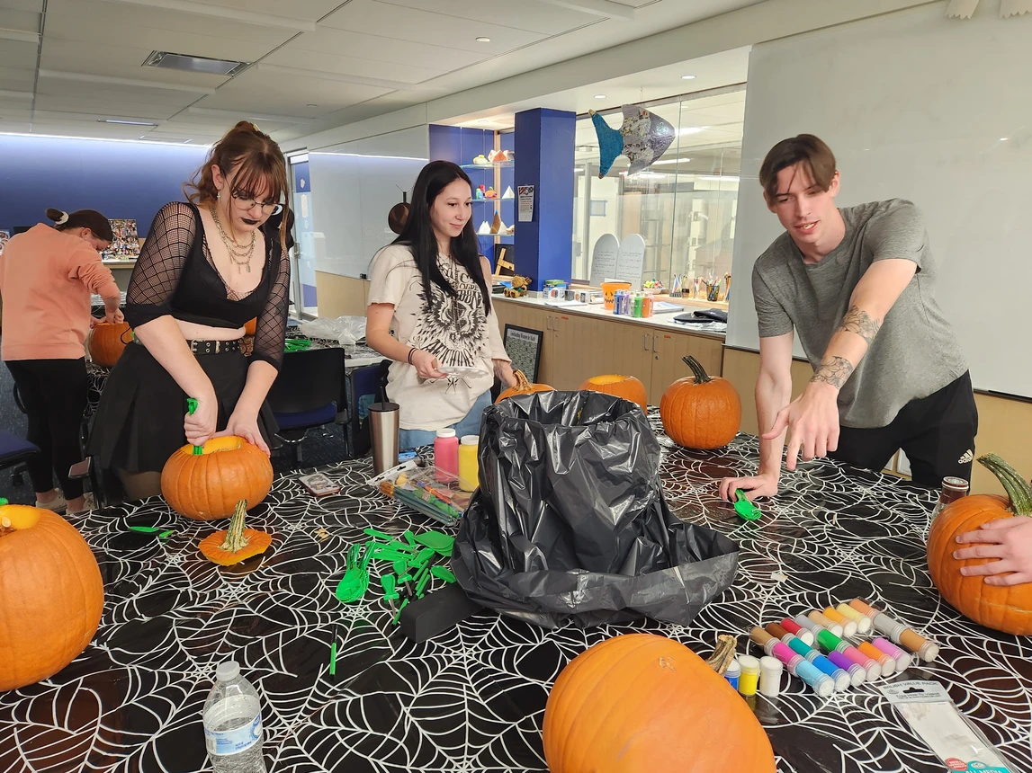Students carving pumpkins
