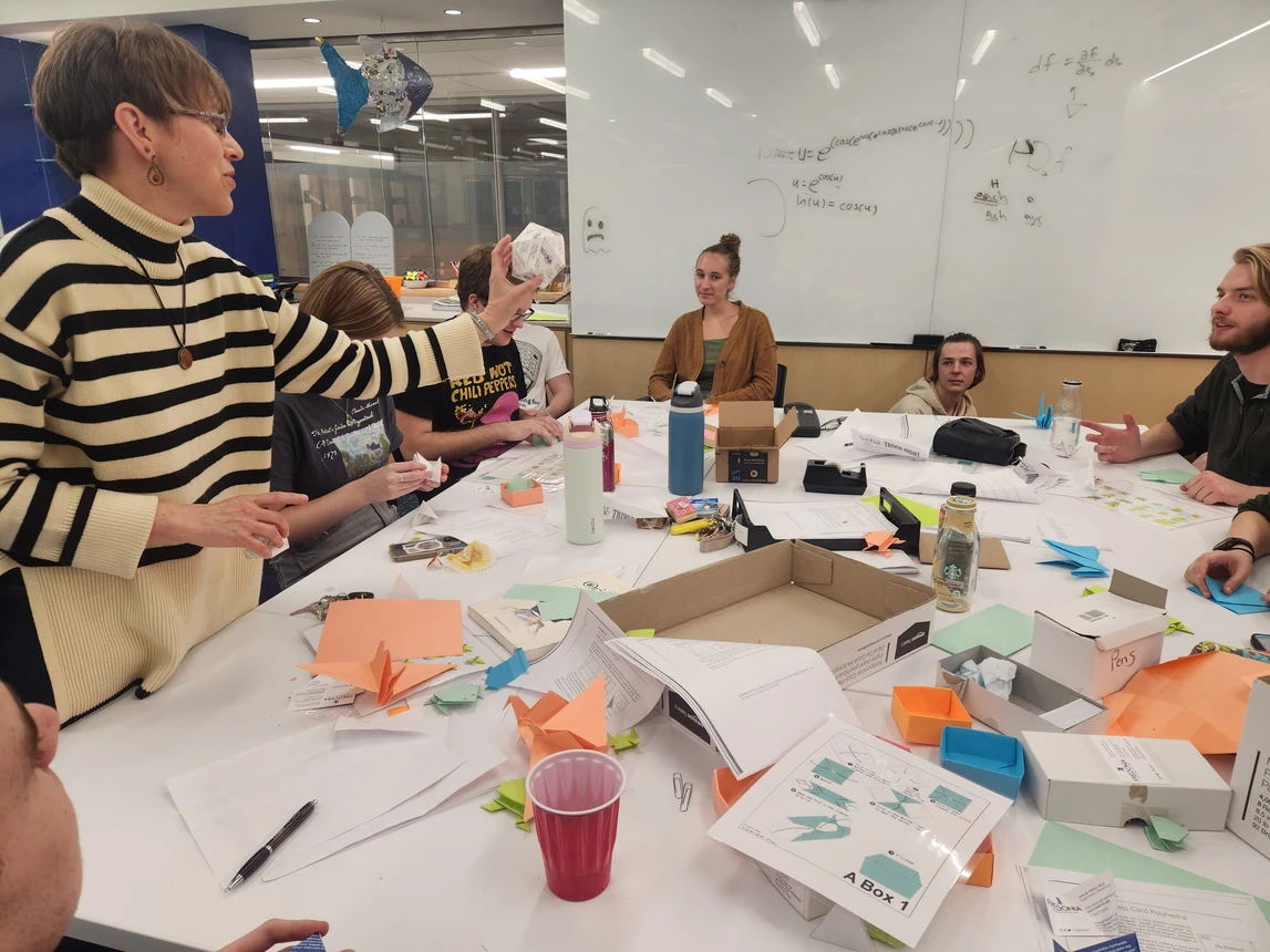 Professor showing students origami