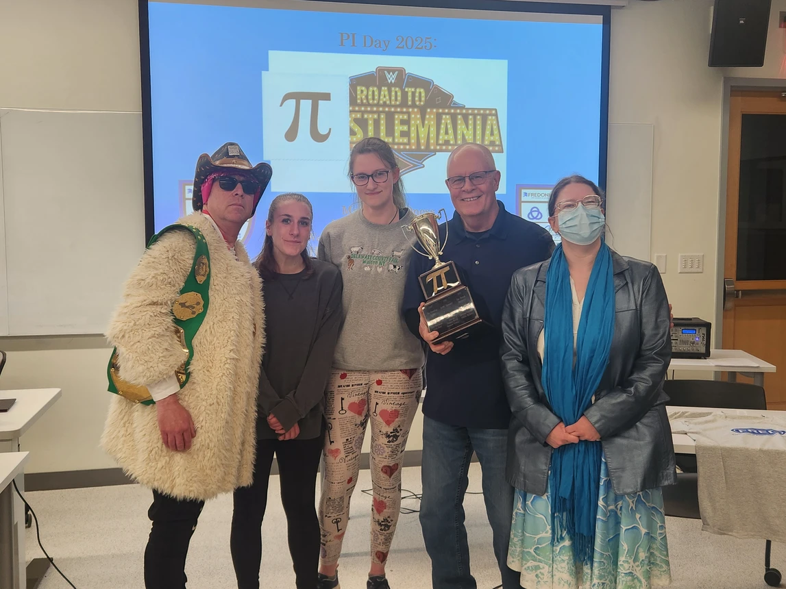 Students and professors holding trophy