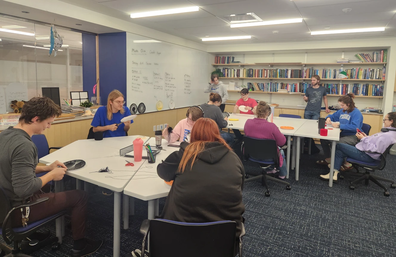 Students doing a craft at tables