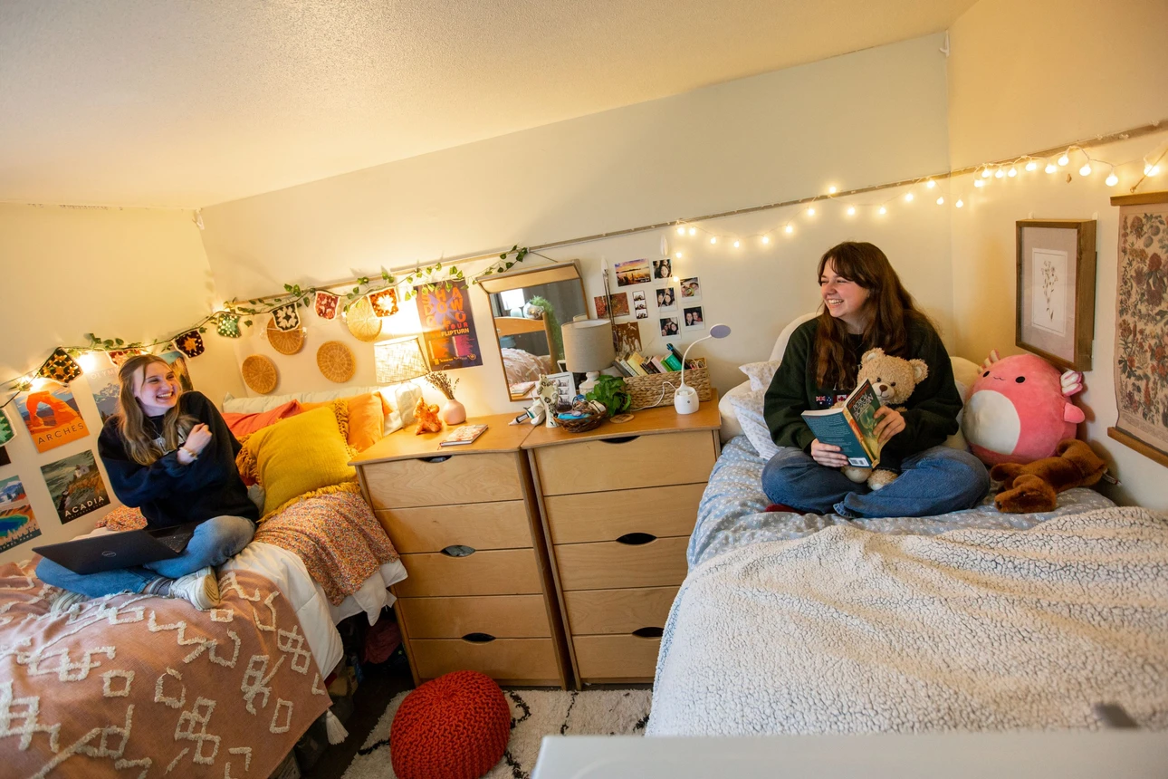 Grissom Hall bedroom featuring 2 students laughing.