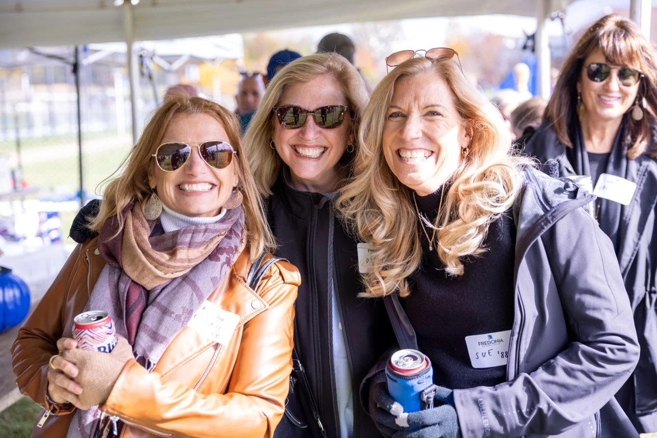 Four women pose outdoors