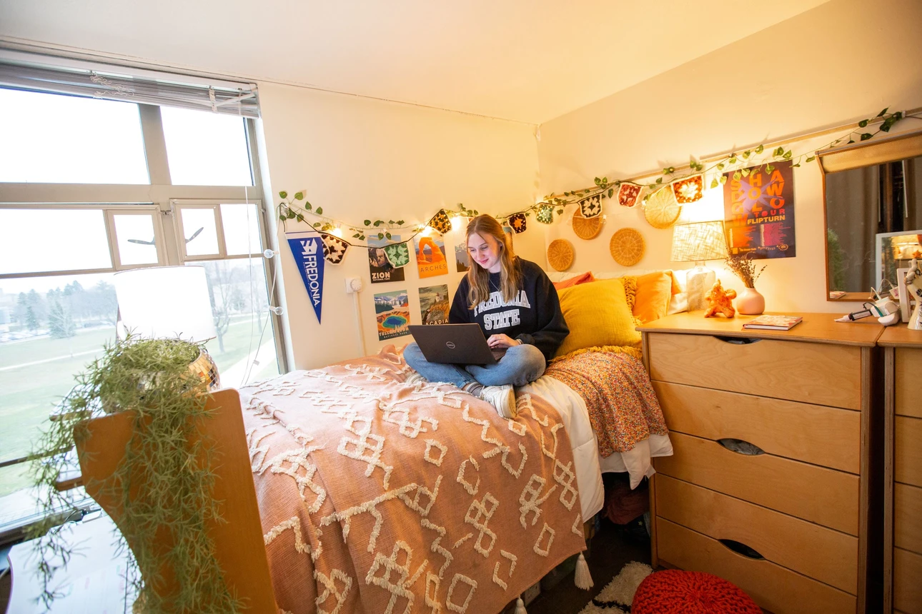Grissom Hall bedroom featuring 1 student reading.