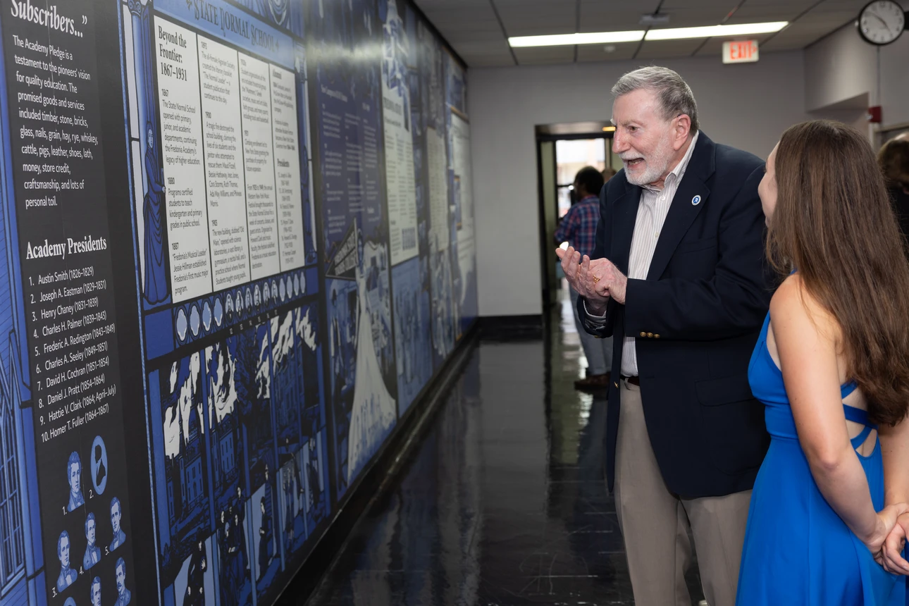 Former SUNY Fredonia President Dennis Hefner talks with artist Erin Ruffino ('19)