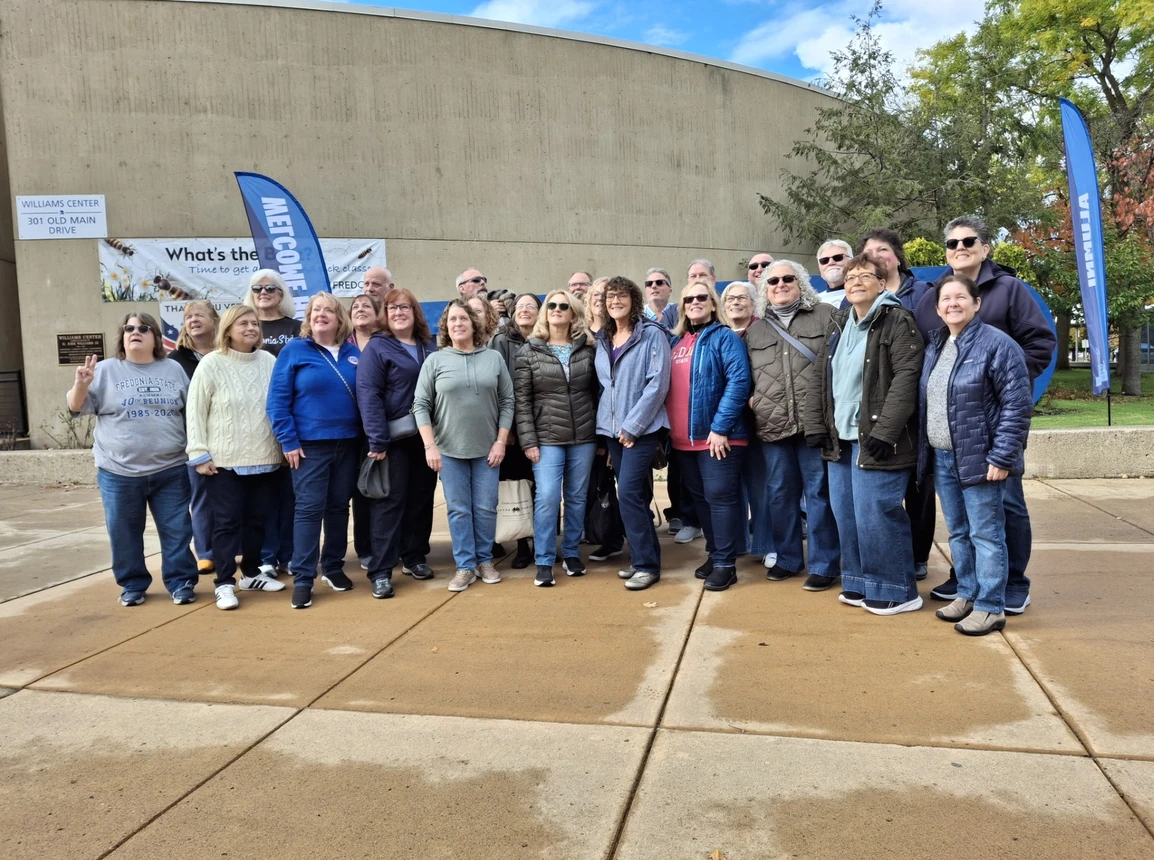 Large group of people pose outdoors