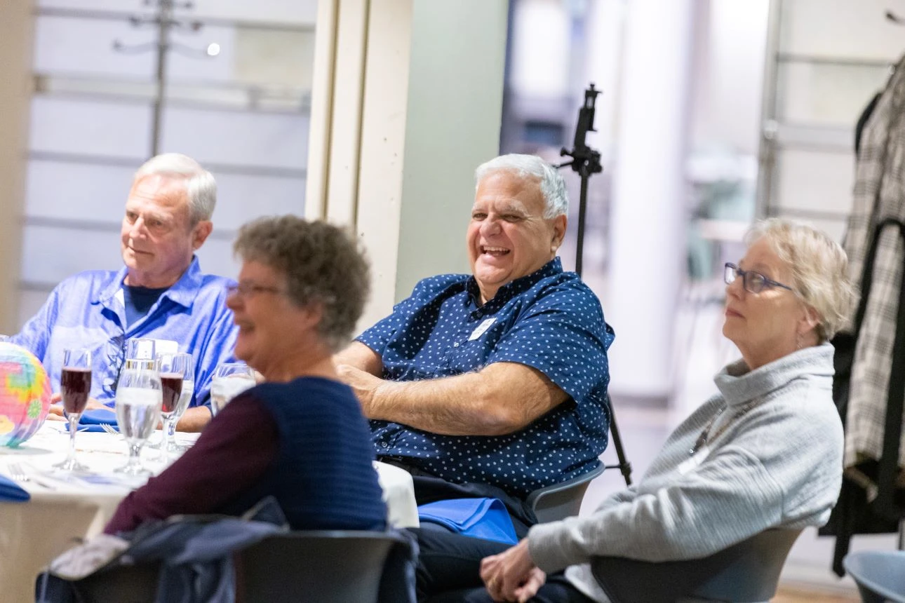 People smiling at a table