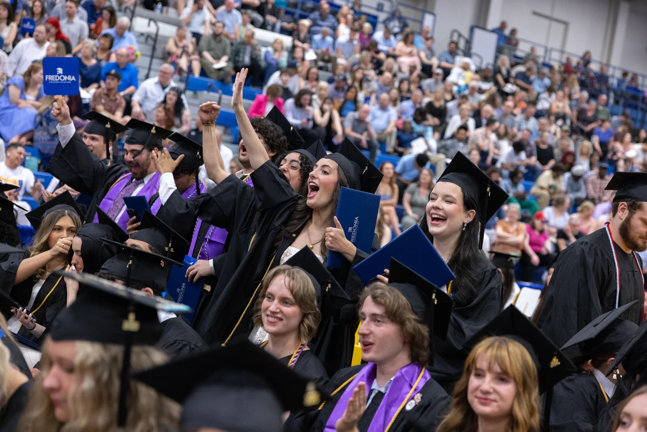 Students cheering for other graduates 