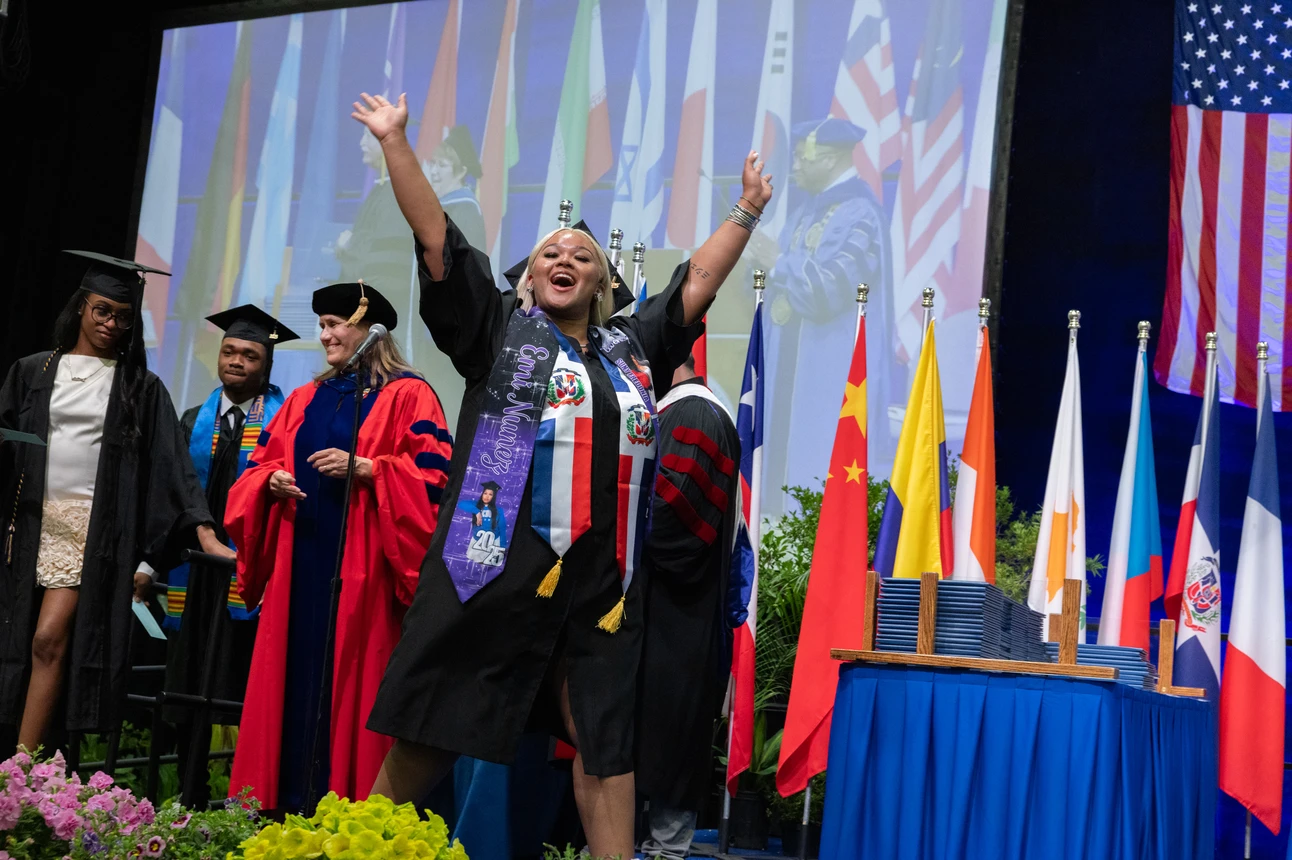 Fredonia student crossing the stage at commencement